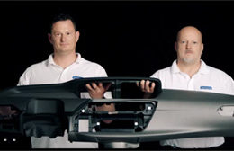 Zwei Mitarbeiter der Faurecia Innenraum Systeme halten ein gemeinsam ein Armaturenbrett in der Hand. Studioaufnahme der mp-film Filmproduktion Karlsruhe